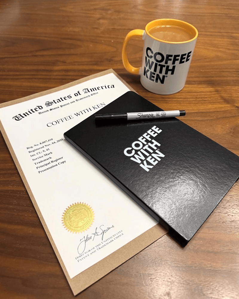 Coffee with Ken federal trademark registration certificate, mug, and notebook